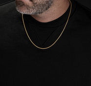 Man Wearing Black Shirt with Simple Gold Chain Necklace
