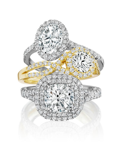 Stack of three diamond engagement rings in white and yellow gold