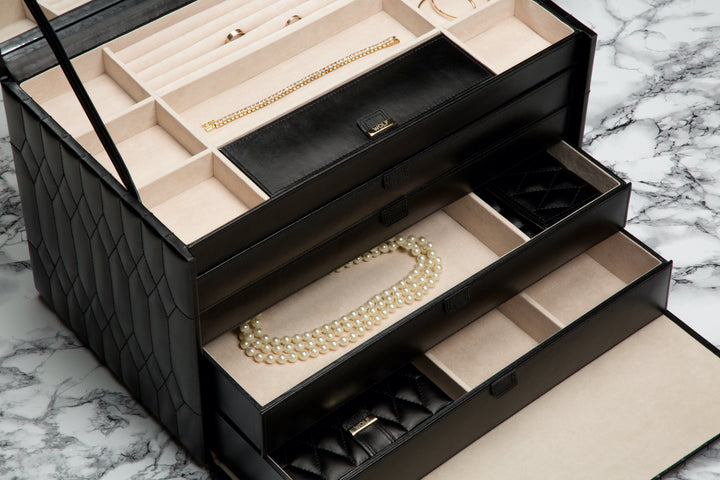 Jewelry box with properly stored necklace, bracelet, and rings