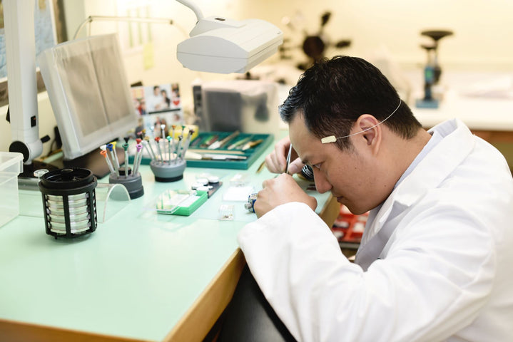Wristwatch Repair Technician Works at a Desk