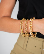 Model Wearing Three Yellow Gold Chain Link Bracelets from Fink's Jewelers