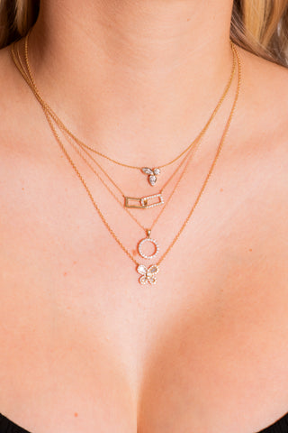 Model wears four pendant necklaces from Fink's Jewelers