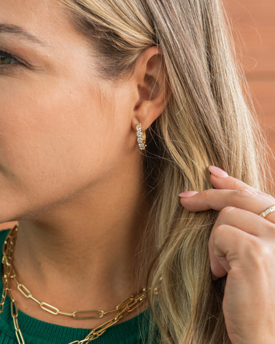Woman wearings classic huggie earring style