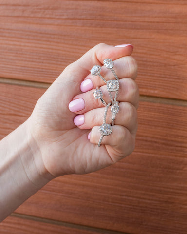 Woman with Pink Nails Displaying 7 Diamond Rings