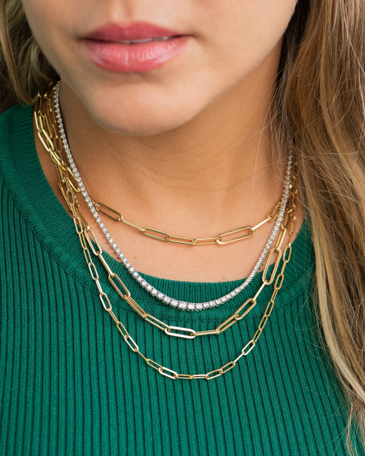 Woman wearing mixed metal layered necklaces