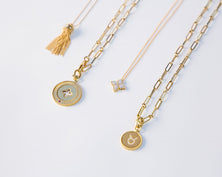 Four yellow gold pendant necklaces in various styles