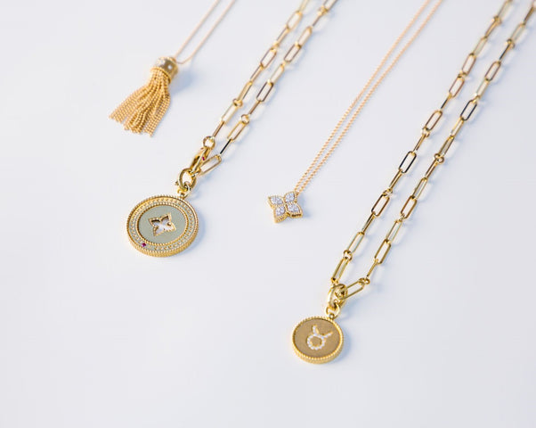 Four yellow gold pendant necklaces in various styles