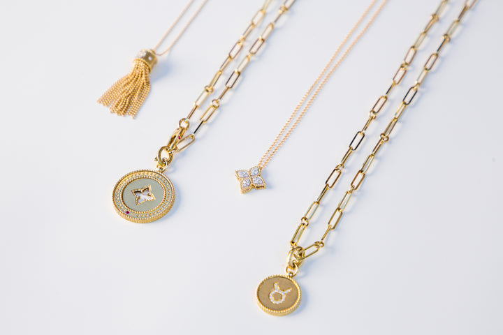 Four Gold Necklaces on a White Background