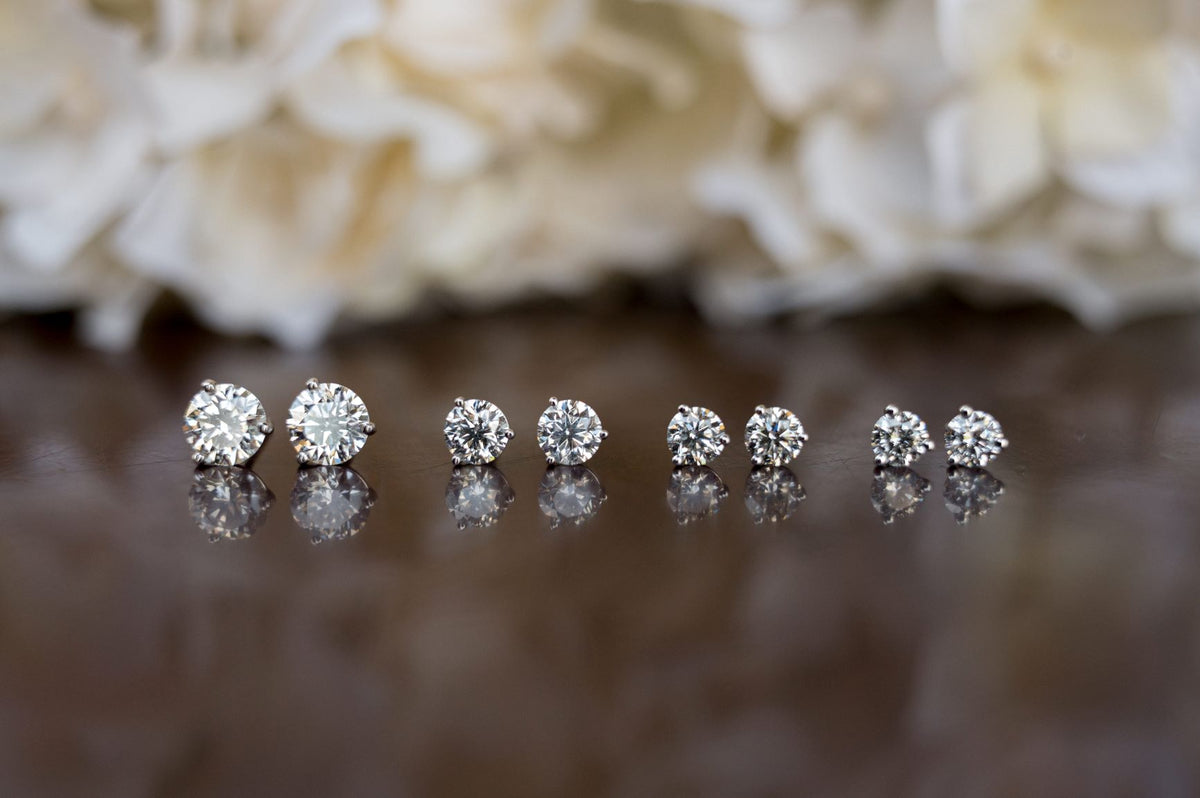Four pair of diamond stud earrings in different sizes