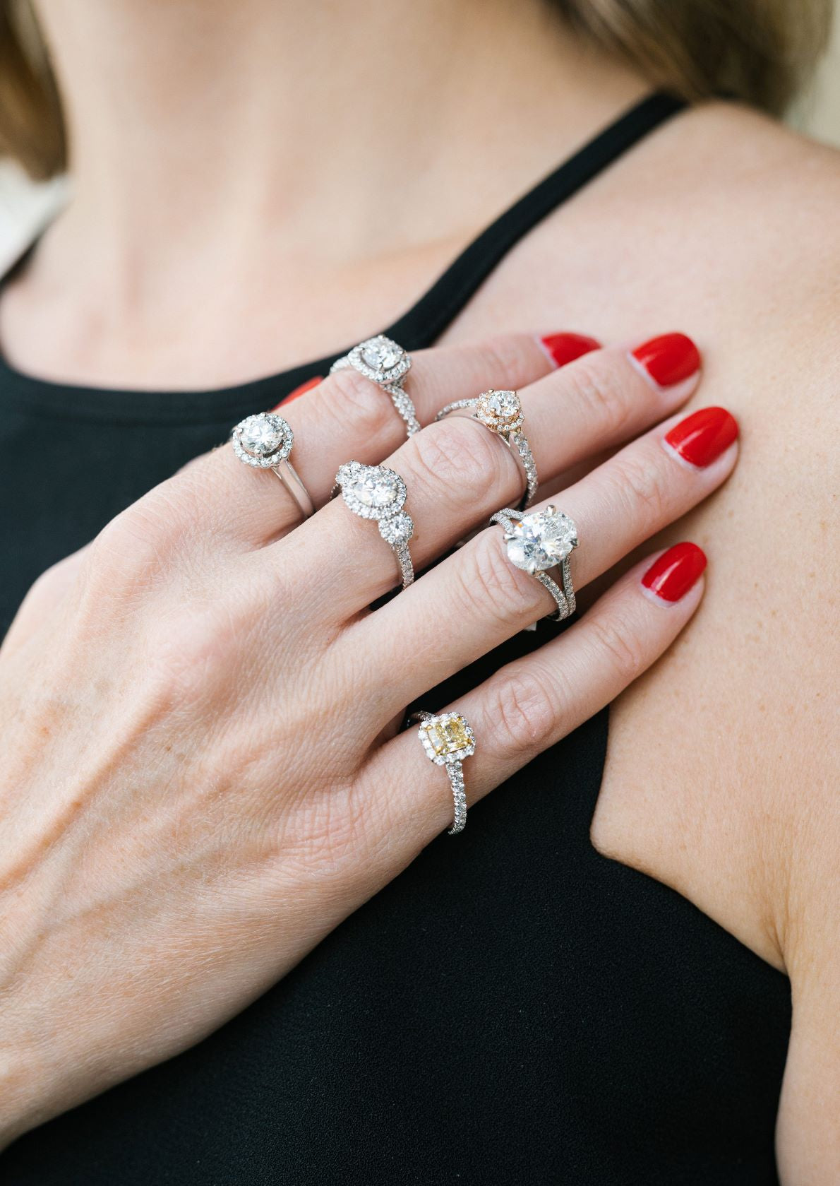 Woman modeling six unique diamond engagement ring styles