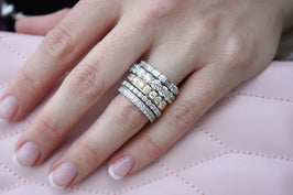 Stack of diamond bands on woman's ring finger