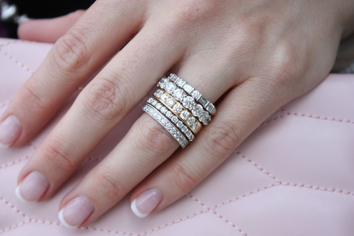 Stack of diamond bands on woman's ring finger