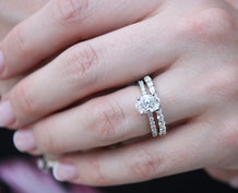 Woman wearing engagement ring and diamond wedding band