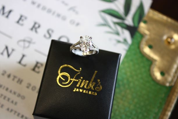 Diamond Engagement Ring on Fink's Jewelers Box with Wedding Invitation Background