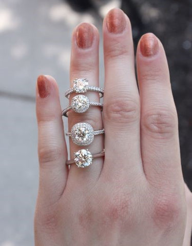 Woman's Hand with 4 Diamond Rings on Ring Finger