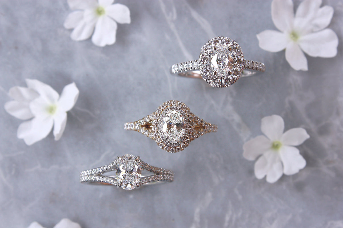 Three different styles of diamond engagement rings on floral background