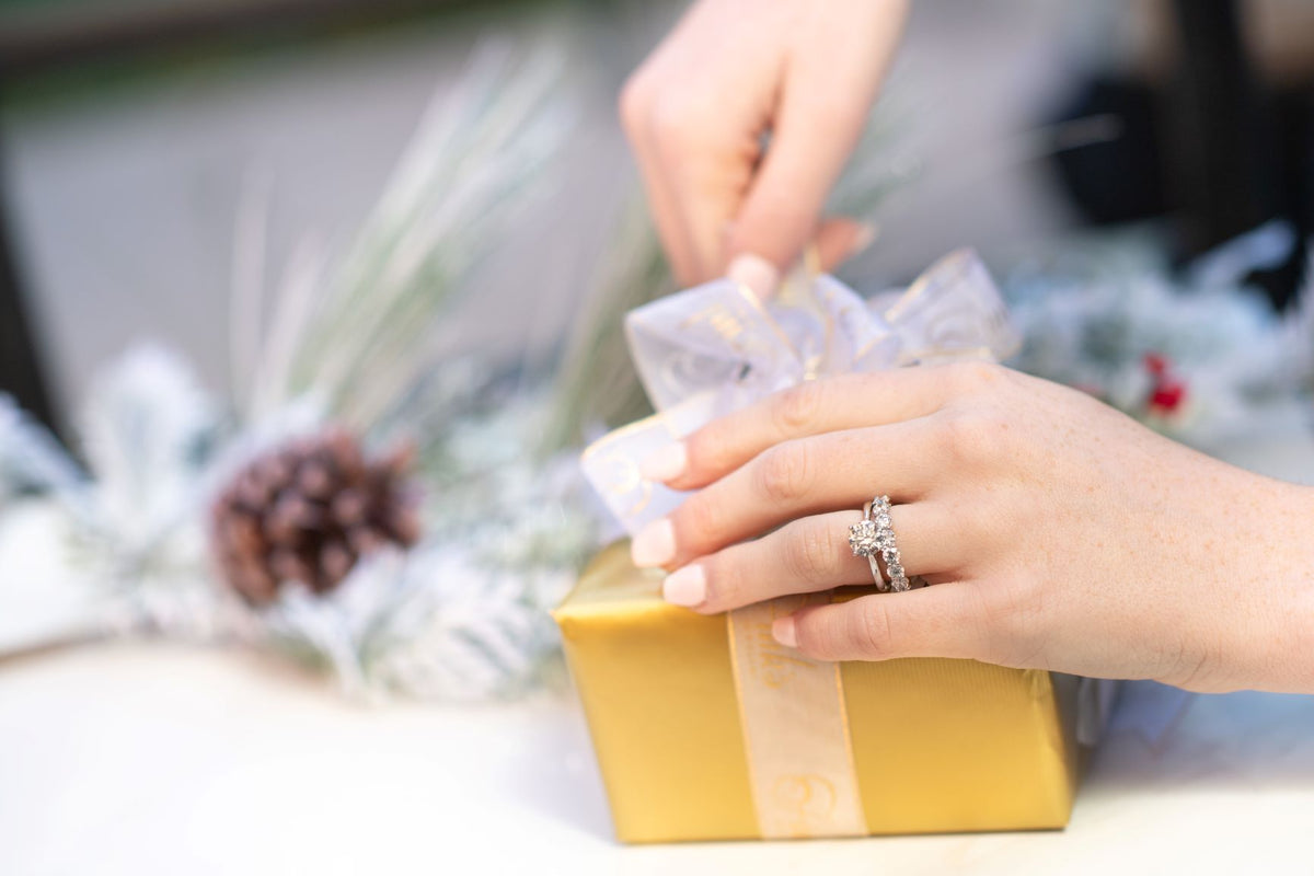 Woman opens Fink's Jewelers jewelry gift