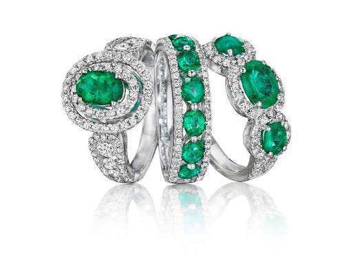 Three diamond and emerald wedding rings