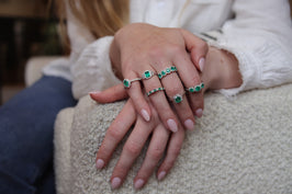 Woman Modeling Six Emerald Rings