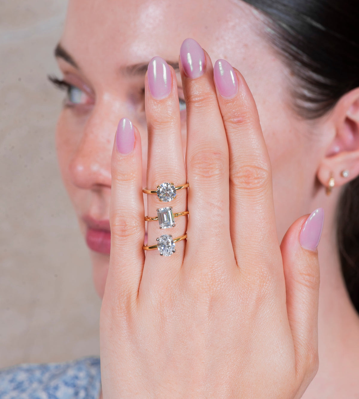 Woman modeling three diamond engagement rings