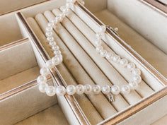 Pearl Necklace with M Initial Laying in Jewelry Box