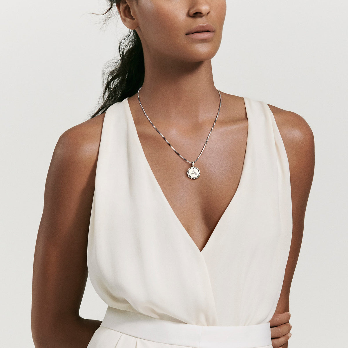 Woman wearing an "A" letter initial pendant necklace