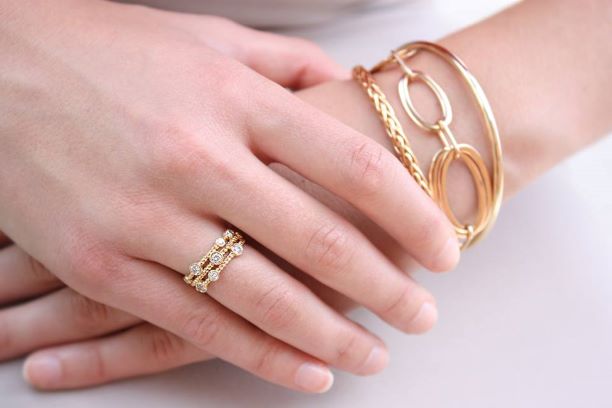 Woman Wearing Yellow Gold Rings and Bracelets