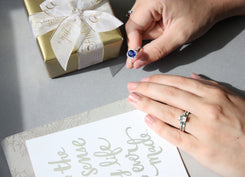 Gift box, card, and Fink's Jewelers anniversary gifts