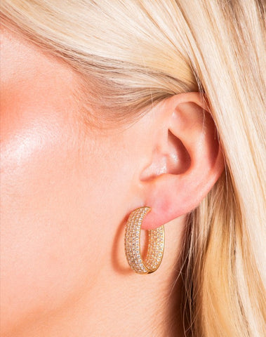 Model Wearing Gold Hoop Earrings with Diamonds from Fink's Jewelers