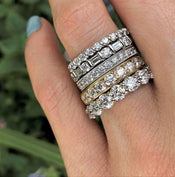 Different styles of diamond wedding bands on woman's ring finger