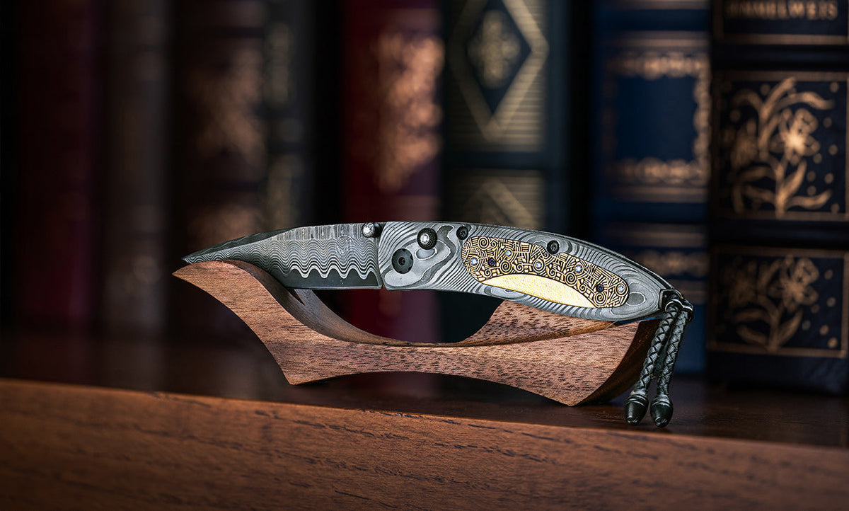 William Henry knife on wood display stand