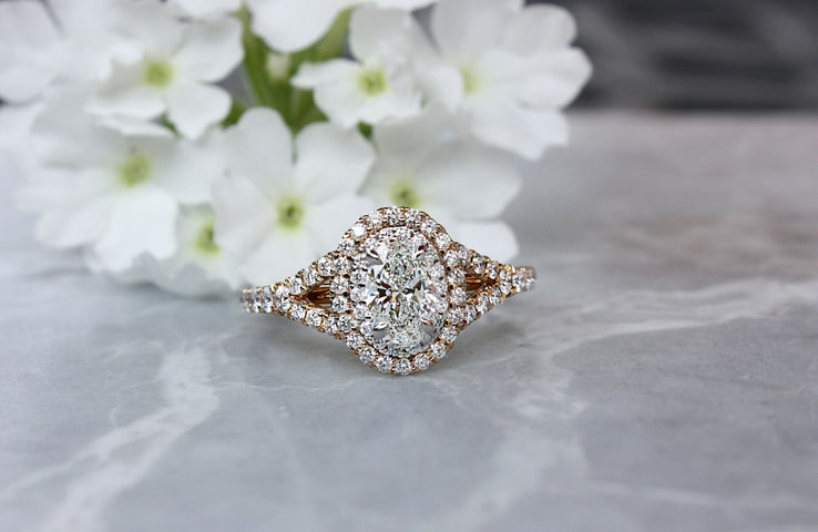 engagement ring on marble by white flowers