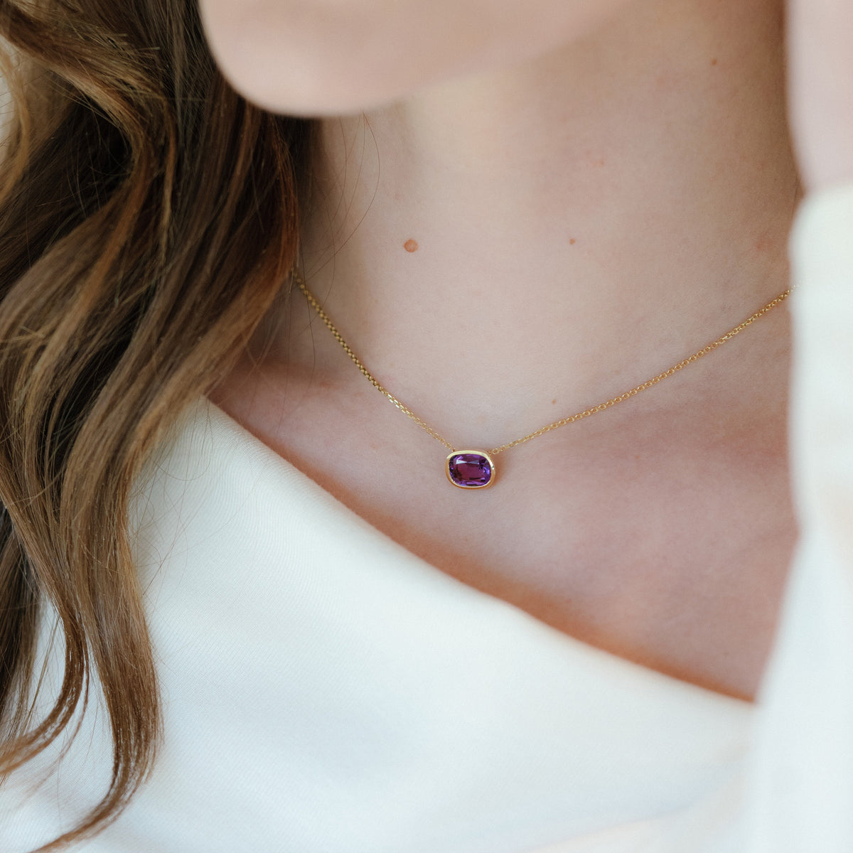 Woman wearing amethyst pendant necklace