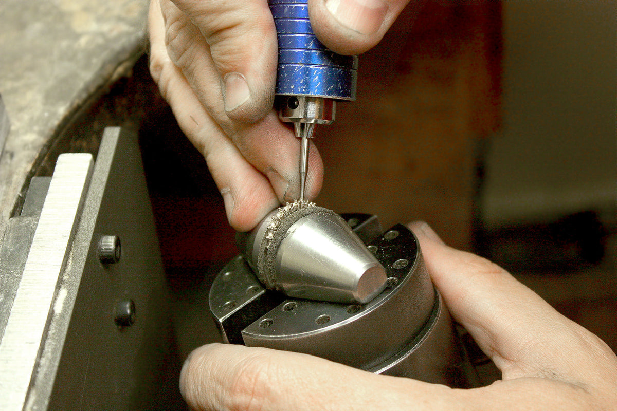 Professional jeweler repairs a wedding band