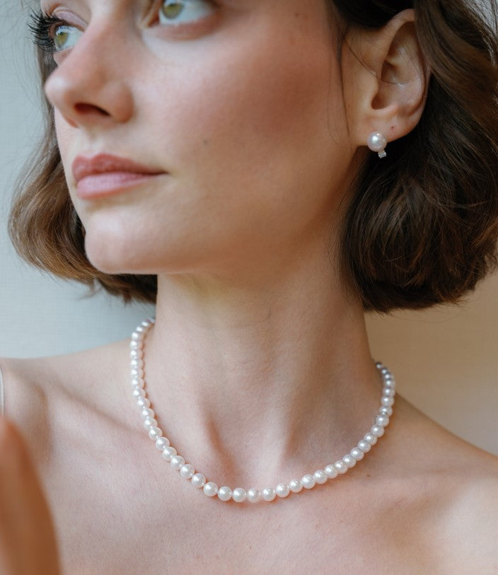 Model wearing pearl necklace from Fink's Jewelers