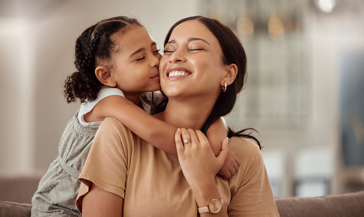 Daughter giving mother a kiss on the cheek