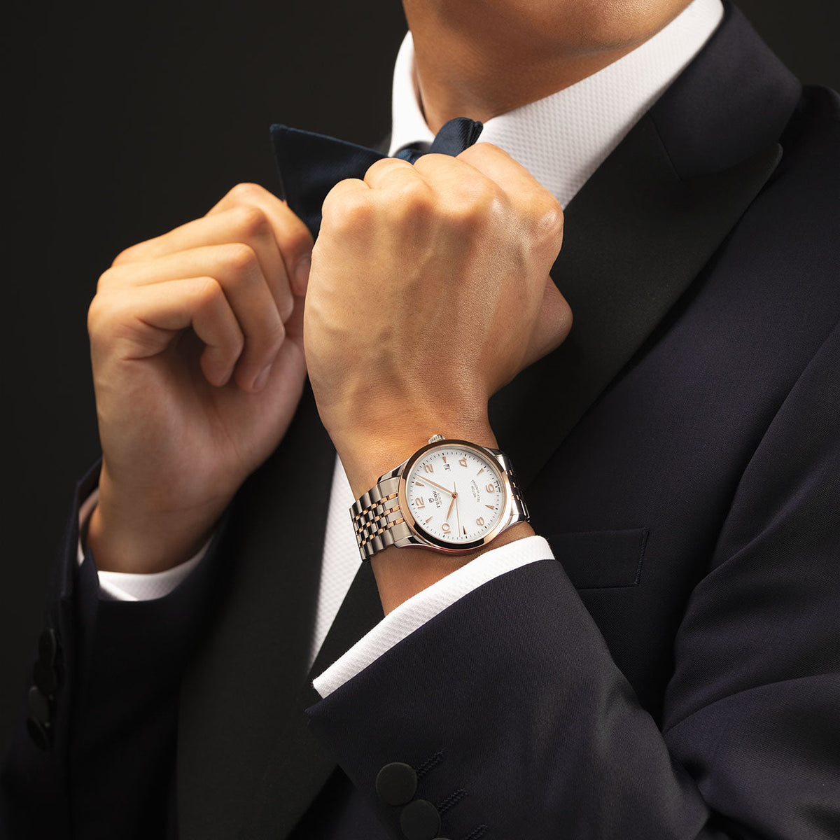 Man in suit wearing a TUDOR watch
