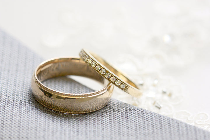 Men's gold wedding ring with women's diamond band