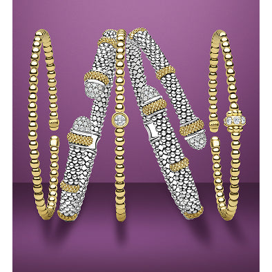 Set of gold and silver bangles on a purple background