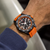 Model wearing Breitling Endurance Pro 44 Watch with Orange Rubber Strap