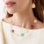 Woman wearing Marco Bicego Lunaria Yellow Gold Collar Necklace with Mixed Gemstones