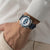 Man wearing Breitling Top Time B01 Racing 38mm Watch with Dark Blue Leather Strap