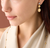 Woman wearing Marco Bicego Siviglia Mixed Metals Triple Drop Earrings with Diamond Accent