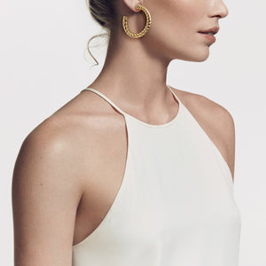 Woman Wearing David Yurman Cable Classics Hoop Earrings in 18K Yellow Gold