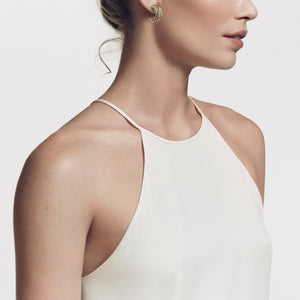 Model Wearing David Yurman Crossover Huggie Hoop Earrings with 18K Yellow Gold